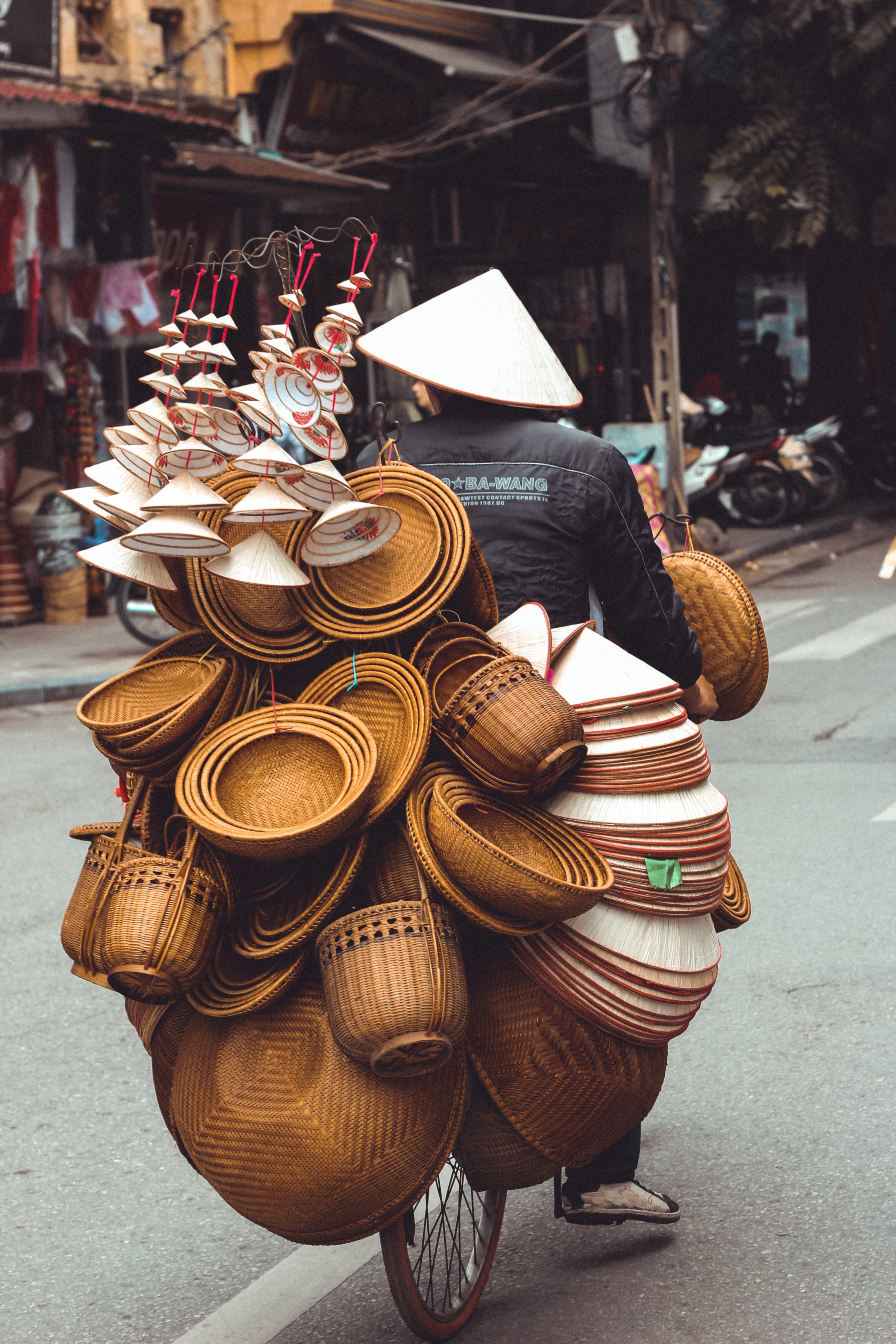 man-riding-bicycle-with-bowls-and-baskets.jpg